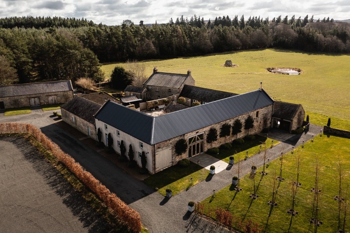 Aerial view of Healey Barn, with the surrounding field and woodland